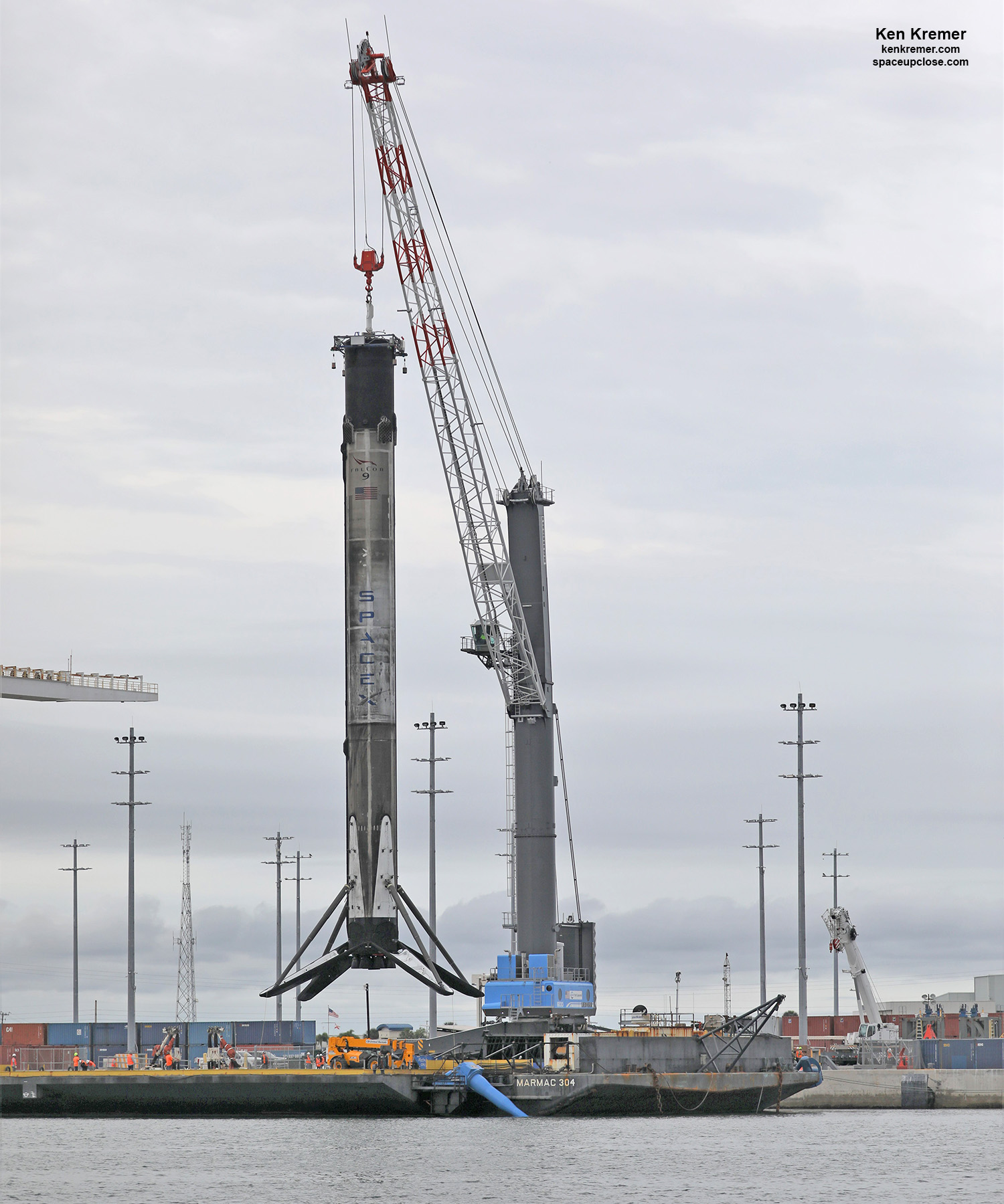 1st Quadruply Launched/Landed SpaceX 1st Stage Booster Craned off Droneship onto Land using new Mobile Harbor Crane: Photos