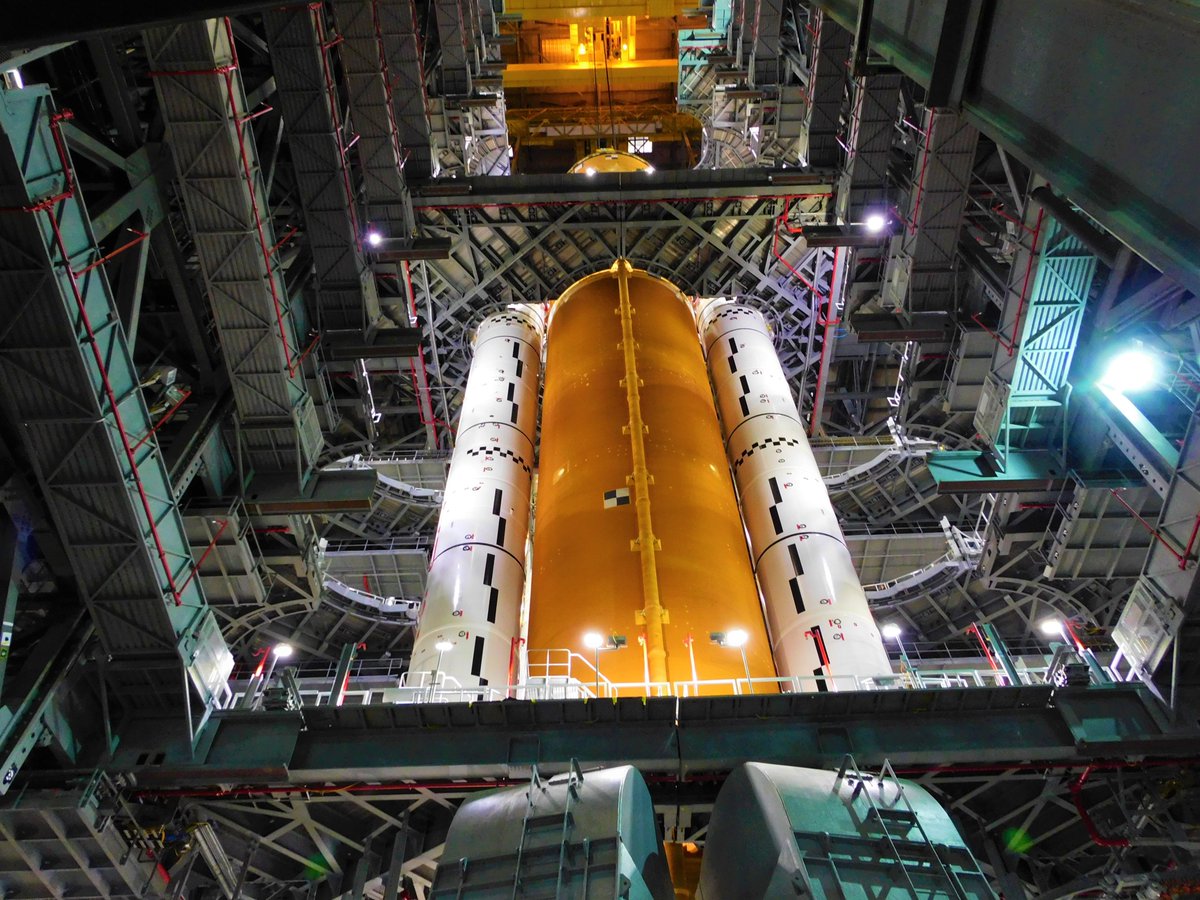 NASA’s 1st SLS Core Stage Lifted Vertical and Stacked Beside Boosters in VAB at Kennedy Space Center